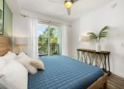 Thumbnail 17 of 66 - a bedroom with a blue bed and a balcony