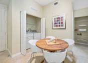 Thumbnail 42 of 44 - a dining room with a table and chairs and a kitchen