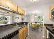 Thumbnail 41 of 41 - a kitchen and dining room with a sink and a table