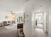Thumbnail 34 of 41 - the living room and dining room of a house with white walls and wood floors