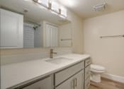Thumbnail 3 of 44 - a bathroom with a sink and a toilet and a mirror