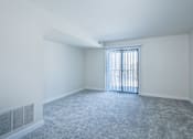 Thumbnail 23 of 44 - A room with a carpeted floor and a window with blinds.