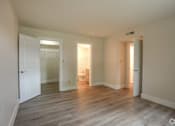 Thumbnail 14 of 44 - a living room with a hard wood floor and white doors