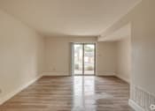 Thumbnail 13 of 44 - an empty living room with a sliding glass door to a patio