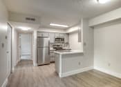 Thumbnail 5 of 44 - an empty kitchen with stainless steel appliances and white cabinets