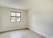 Thumbnail 11 of 44 - an empty living room with white walls and a window