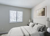 Thumbnail 39 of 44 - A bedroom with a large bed and a painting on the wall.
