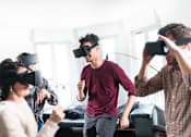 Thumbnail 6 of 7 - People wearing virtual reality headsets in a room.