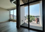 Thumbnail 18 of 26 - an open living room with large windows and a balcony