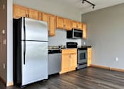 Thumbnail 16 of 26 - a kitchen with wooden cabinets and stainless steel appliances