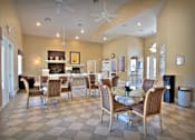 Thumbnail 11 of 16 - A dining room with a checkered floor and a fireplace.