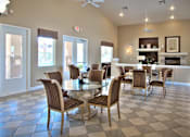 Thumbnail 6 of 16 - A dining room with a checkered floor and a fireplace.