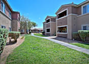 Thumbnail 13 of 16 - A sunny day at a residential area with apartment buildings and green lawns.