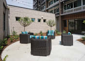 Thumbnail 11 of 50 - A patio with a table and chairs at Denver Metro Village Apartments, Denver