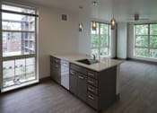 Thumbnail 26 of 50 - A kitchen with a large island and a view of the outside at Denver Metro Village Apartments, Colorado, 80204