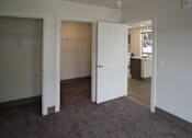Thumbnail 27 of 50 - A room with a carpeted floor and two open doors at Denver Metro Village Apartments, Denver, CO