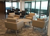 Thumbnail 32 of 50 - A room with a carpeted floor and a table with chairs at Denver Metro Village Apartments, Colorado