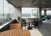 Thumbnail 29 of 50 - A modern outdoor seating area with a view of the city at Denver Metro Village Apartments, Denver