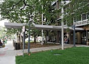 Thumbnail 4 of 50 - A tree is in front of a building at Denver Metro Village Apartments, Colorado