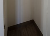 Thumbnail 49 of 50 - Empty white closet with a shelf and a door at Denver Metro Village Apartments, Denver, CO