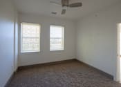 Thumbnail 42 of 50 - A room with a ceiling fan and carpeted floor at Denver Metro Village Apartments, Denver, 80204