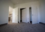 Thumbnail 45 of 50 - A room with white doors and carpeted floor at Denver Metro Village Apartments, Denver, CO
