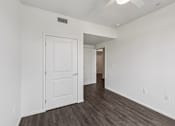 Thumbnail 8 of 42 - A white door is in a room with wood flooring.