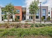 Thumbnail 1 of 42 - A modern building with a landscaped front yard.