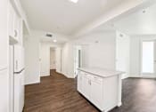 Thumbnail 27 of 42 - A kitchen with white appliances and cabinets.