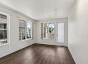 Thumbnail 3 of 42 - A room with a white wall and a brown floor.