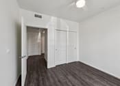 Thumbnail 15 of 42 - A room with a white ceiling and a wooden floor.