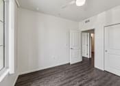 Thumbnail 18 of 42 - A room with white walls and a window on the left side.