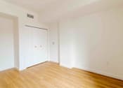 Thumbnail 11 of 17 - A room with a white door and a white wall.