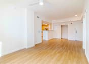 Thumbnail 12 of 17 - A room with wooden floors and white walls.