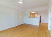Thumbnail 8 of 17 - A room with wooden floors and white walls.