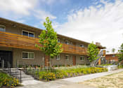 Thumbnail 5 of 11 - A row of townhouses with a sidewalk in front.