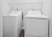 Thumbnail 17 of 49 - a small laundry room with a washer and dryer