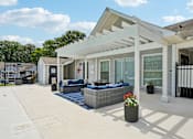 Thumbnail 4 of 107 - A white patio with a black railing and a white house in the background.