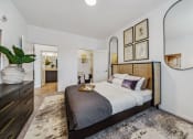 Thumbnail 10 of 38 - a bedroom with a large bed and a mirror  at Plat 4 at Research Triangle, Durham