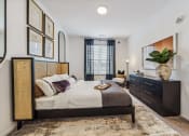 Thumbnail 7 of 38 - a bedroom with a bed and a dresser  at Plat 4 at Research Triangle, Durham, NC, 27703