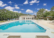Thumbnail 1 of 49 - a pool with lounge chairs and a house in the background