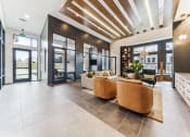 Thumbnail 28 of 38 - a lobby with couches and chairs and glass doors  at Plat 4 at Research Triangle, Durham, North Carolina
