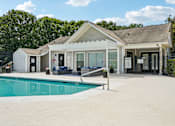 Thumbnail 5 of 107 - A house with a pool in front of it.