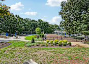 Thumbnail 99 of 107 - A park with a playground and a tennis court.