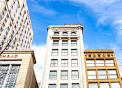 Thumbnail 30 of 32 - looking up at a tall white building with a blue sky in the background at 26 West, Managed by Buckingham Urban Living, Indianapolis