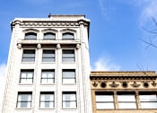 Thumbnail 31 of 32 - the top of a tall white building with a blue sky in the background at 26 West, Managed by Buckingham Urban Living, Indianapolis