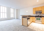 Thumbnail 7 of 32 - a kitchen with a stove top oven next to a window at 26 West, Managed by Buckingham Urban Living, Indianapolis