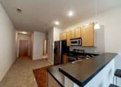 Thumbnail 6 of 32 - a kitchen with a black counter top and a black stove top oven at 26 West, Managed by Buckingham Urban Living, Indianapolis