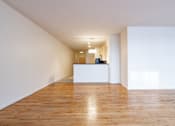 Thumbnail 23 of 32 - an empty living room with white walls and wood floors at 26 West, Managed by Buckingham Urban Living, Indianapolis