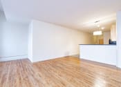 Thumbnail 22 of 32 - an empty living room with white walls and wood floors at 26 West, Managed by Buckingham Urban Living, Indianapolis